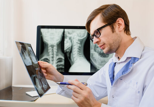 radiologist analyzing a cervical spine x-ray of a patient with spinal chronic pain..