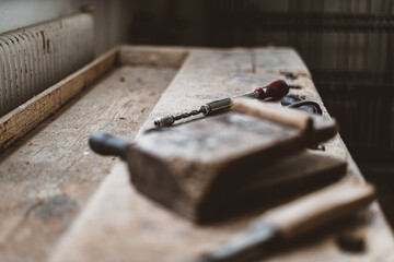 Collection of vintage woodworking tools on a rough workbench and blank copy space: carpentry, craftsmanship and handwork concept, flat lay