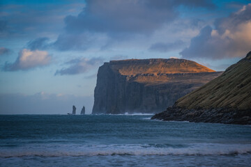 Picturesque landscape with spectacular view to village Tjornuvik Tjornevig on Island Streymoy of the Faroe islands. View to legendary sea stacks Risin og Kellingin.The Giant and the Witch. November 21