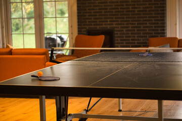 Table tennis bat with ball on a table tennis table. Pause before the game.
