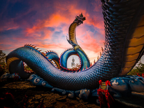Naga with sunset time on Background Nage head in Buddhist art at Phu manorom temple mukdahan Province, Thailand
