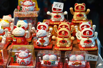Welcoming cat oriental souvenir on sale in oriental fair selective focus Wealth Lucky Waving Kitty Maneki Neko