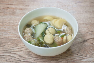 boiled egg sausage and tofu with chop pork couple cabbage topping seaweed soup on bowl