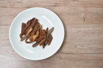 crispy fried salty beef meat and belly arranging on plate