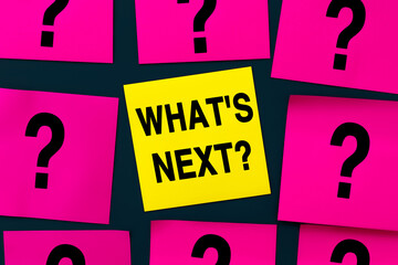 What's Next - inscription on yellow sticker, text concept. A yellow square sticker is the center of...