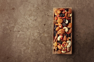 The mix of dried fruits and berries on a stone background.
