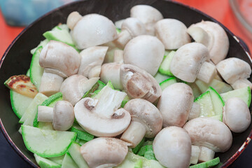 Mushrooms with zucchini frying pan . Preparing a Vegetarian Dinner