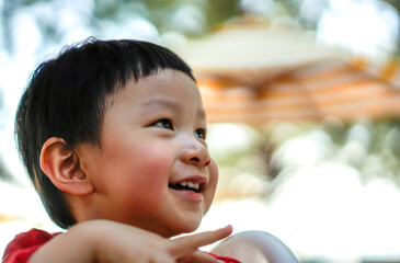 Cute little child thinking, close up, Selective focus, Blurred Background. Portrait of Cute kid thinking at the park.