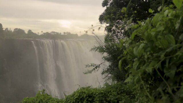 Slow motion shot of the amazing Victoria Falls on the Zambezi River at the border of Zambia and Zimbabwe. The Victoria Falls at the Border of Zimbabwe and Zambia in Africa.