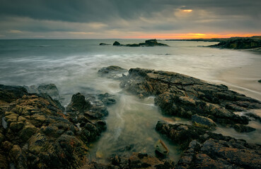 Dramatic sunset seascape scenery of rocky coast at wild atlantic way in county Galway, Ireland 