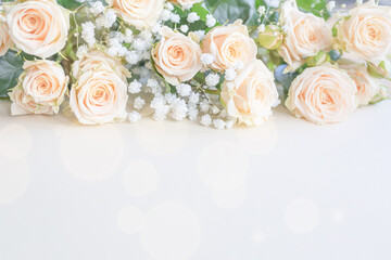 Fototapeta na wymiar Light beige roses flower bouquet on white background. top view
