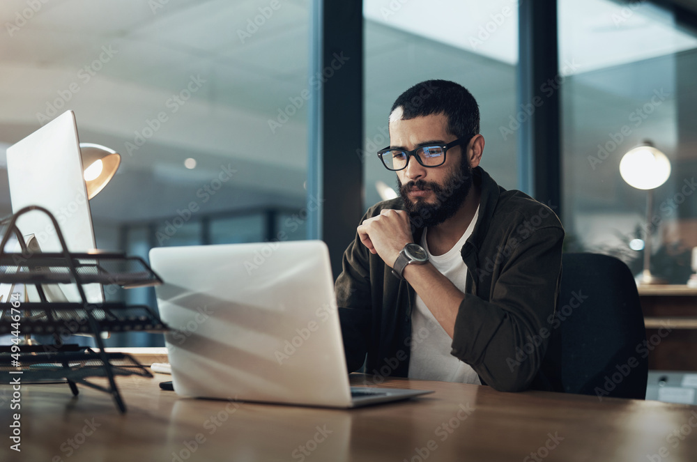 Poster the more you focus the quicker youll find the solution. shot of a young businessman using a laptop d