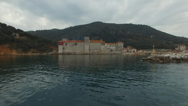 The monastery of Esphigmen, located in the eastern part of the Athos peninsula. Shooting: approaching the monastery on the blue sea water.