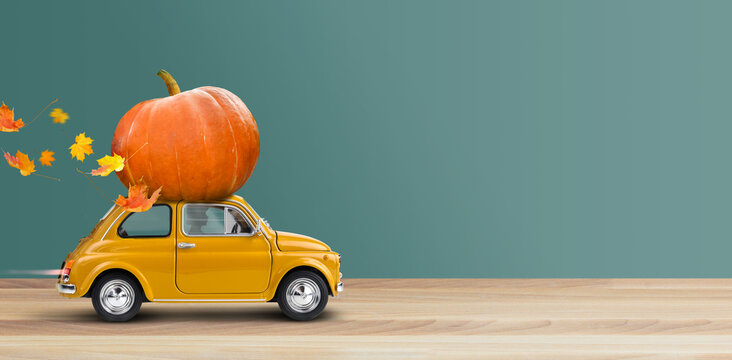 Thanksgiving Is Coming. Yellow Car Is Carrying A Pumpkin