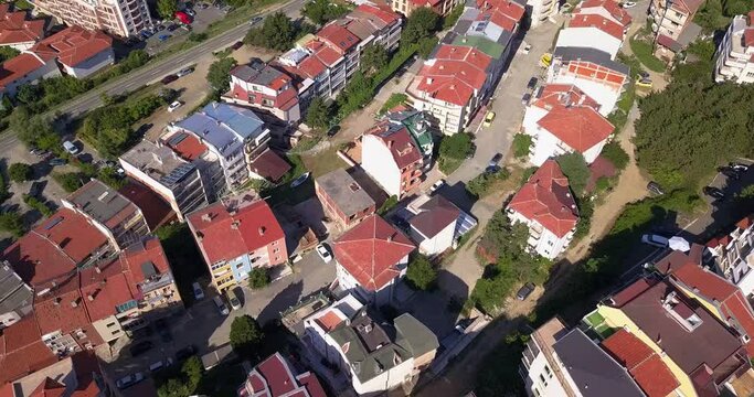 Drone aerial video of the tipical red Bulgarian roofs with solar panels, south of Bulgaria. Alternative energy concept.