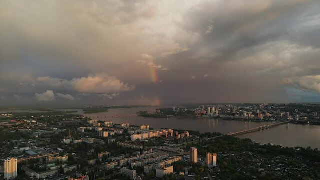 Rainbow over a stormy sky. Gloomy dark sky in the background on a rainy day. Beautiful sunset. city ​​of Dnipro, Ukraine. Drone photography