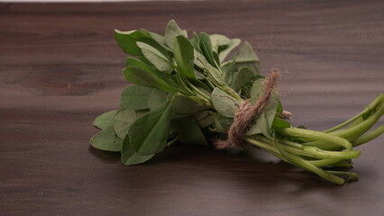 Bundle of fresh spinach isolated on wooden background. Vegan food lifestyle concept, Copy space.