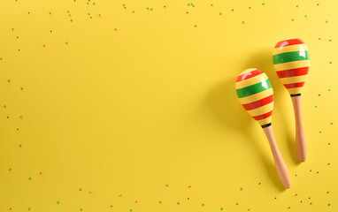 Cinco de Mayo holiday background made from maracas stars on yellow background.