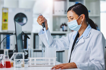 Experimenting makes me happy. Shot of a young female researcher working in a laboratory.