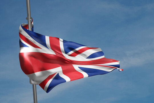 British flag waving in the wind on blue sky background. Union Jack on flagpole. 3D render illustration.