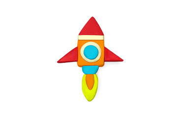 Space rocket molded from multi-colored plasticine on a white background. Rocket in the shape of a spaceship and free space for text. Homemade in the style of cosmonaftics
