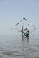 Fototapeta na wymiar Fishing net on the wood construction in the sea