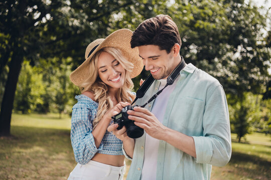 Portrait of two attractive cheerful couple choosing captures snap shot of model pastime portfolio outdoors