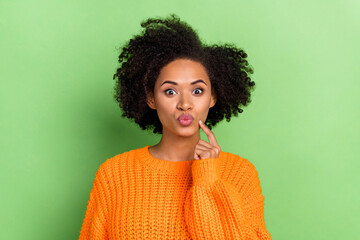 Photo of flirty millennial volume hairdo lady blow kiss wear orange pullover isolated on green color background