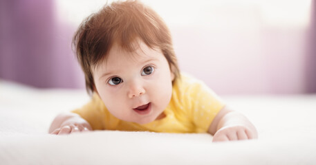 Cute little baby lying on the blanket.