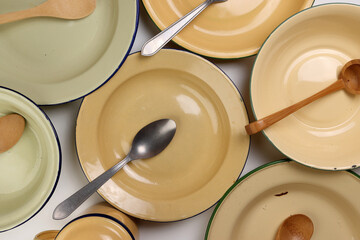 Varity of wooden metal spoon on enamel tin food plate pot bowl retro vintage tableware dinnerware...