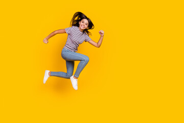 Fototapeta na wymiar Full body profile side photo of young girl jumper movement hurry fast isolated over yellow color background