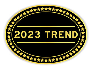 Black and gold color round label sticker with word 2023 trend on white background