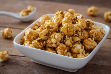 Popcorn with caramel in white bowl