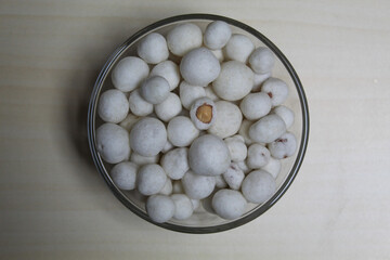 Fototapeta na wymiar Kacang Atom, snack from Indonesia, made from peanut covered by flour dough.