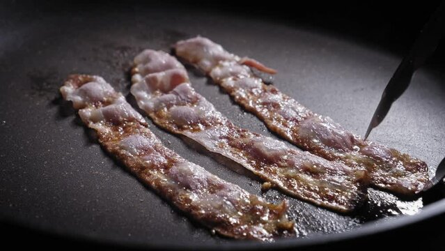 Delicious Bacon Frying In A Pan. close up