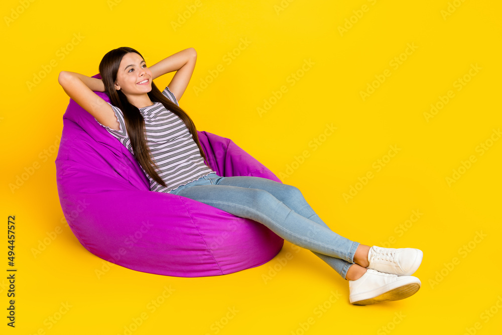 Poster full body profile side photo of youth lady sit soft purple chair arms behind head isolated over yell