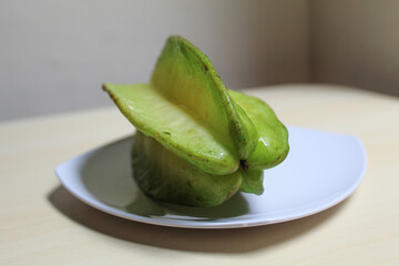 Carambola, or star fruit or 5 fingers, is the fruit of Averrhoa carambola. Green-yellow color.
