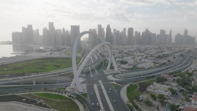 Rotating drone shot around Al Wahda Arche in front of the towers of Dafna.