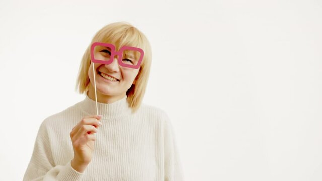 Woman putting on his face Fake paper Glasses, isolated on white. Portrait with space for text on right