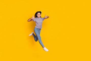 Fototapeta na wymiar Full body photo of young girl jump show thumbs-up approve select ads good isolated over yellow color background