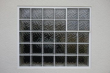 Glass blocks with white cement filling gaps in white house wall, German 70s design (horizontal),...