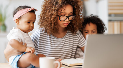 Obraz premium Young irritated African-American mother freelancer trying to work while working remotely with kids