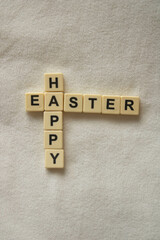 Happy Easter written in scrabble letters on a soft white fleece background	