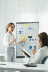 Successful business professionals presenting analytical report while working together with colleagues in the modern office