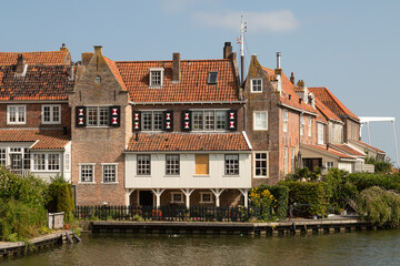 Fototapeta na wymiar Historic canal houses on the old harbor of the picturesque town of Enkhuizen in West Friesland.