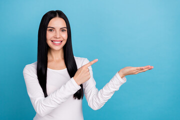 Photo of impressed brunette millennial lady hold index promo wear outfit isolated on blue color background