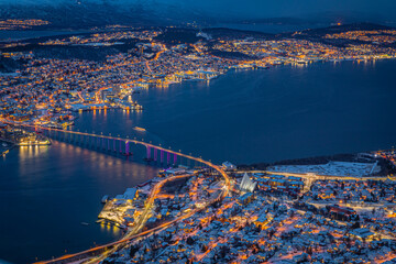 Aerial view of beautiful winter landscape of snow covered town Tromso