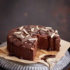 Healthy chocolate cake with almonds non sugar on a plate on the old wooden background. Selective focus. Keto diet.