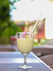 Closeup of Avocado smoothie in wine glass.