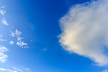 Naklejka na ściany i meble White cloud on blue sky
